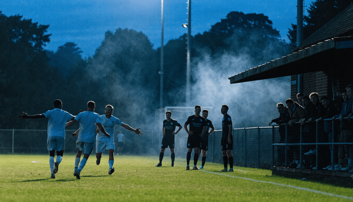Away players celebrate a winning goal under floodlights as home players stand dejected